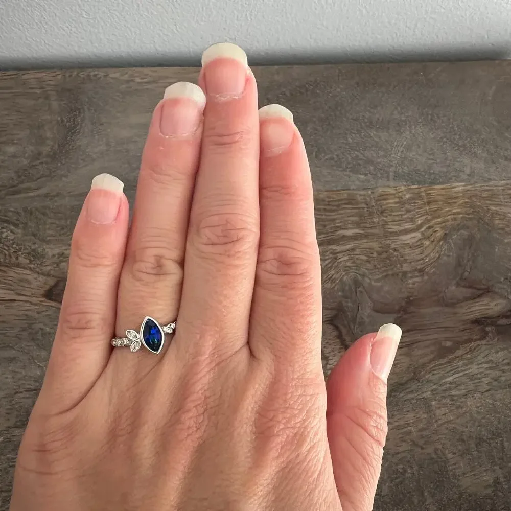 Sapphire blue colored crystal studded elegant ring on silver tone band size 6.25